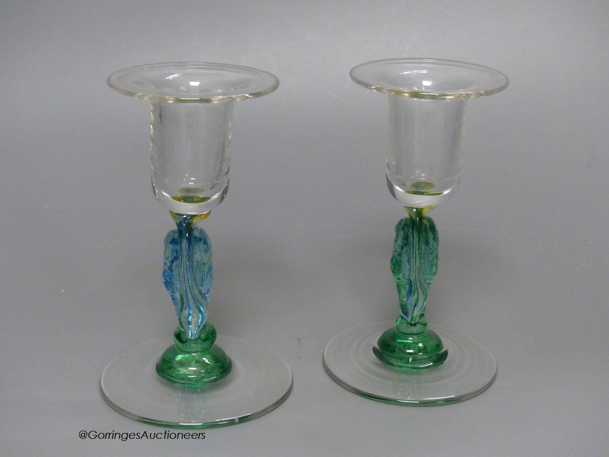 A pair of clear and coloured glass candlesticks by Helen Millard